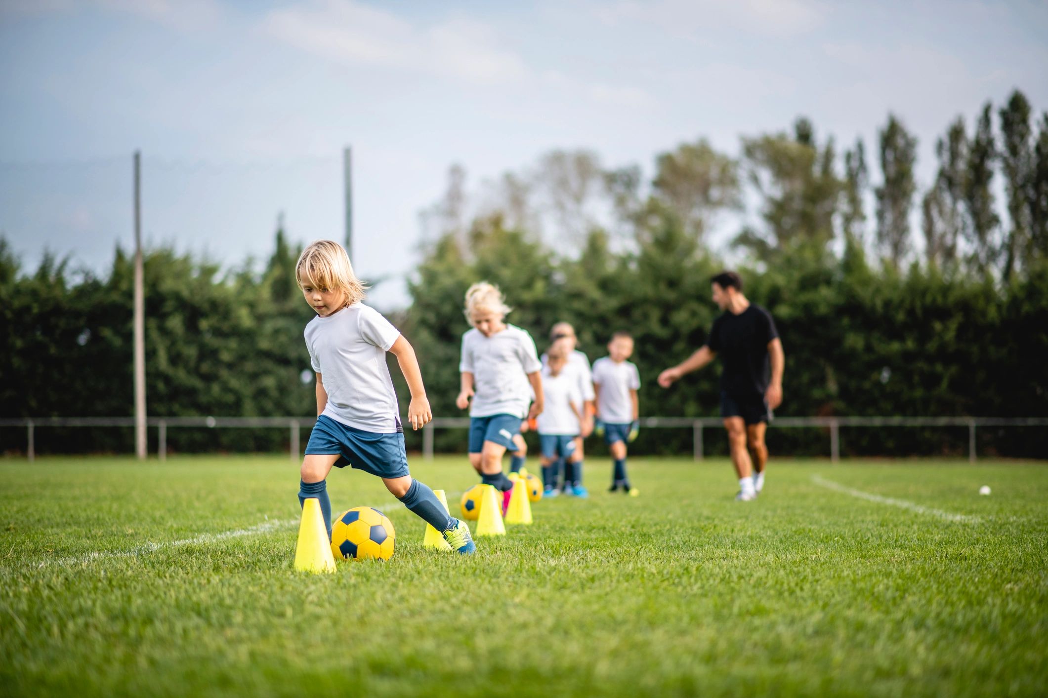 Coach leading youth training drill