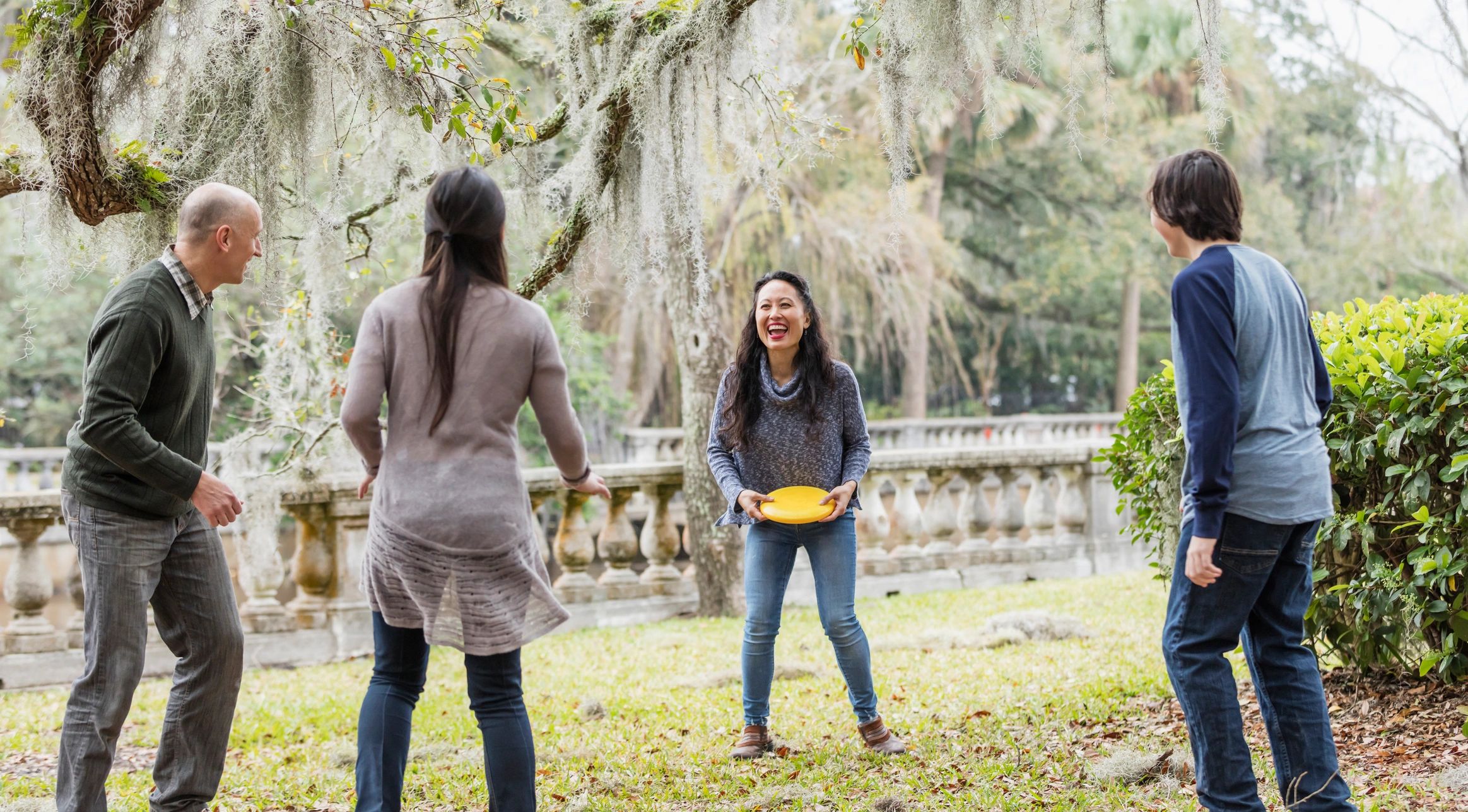 Family playing outdoors in a park