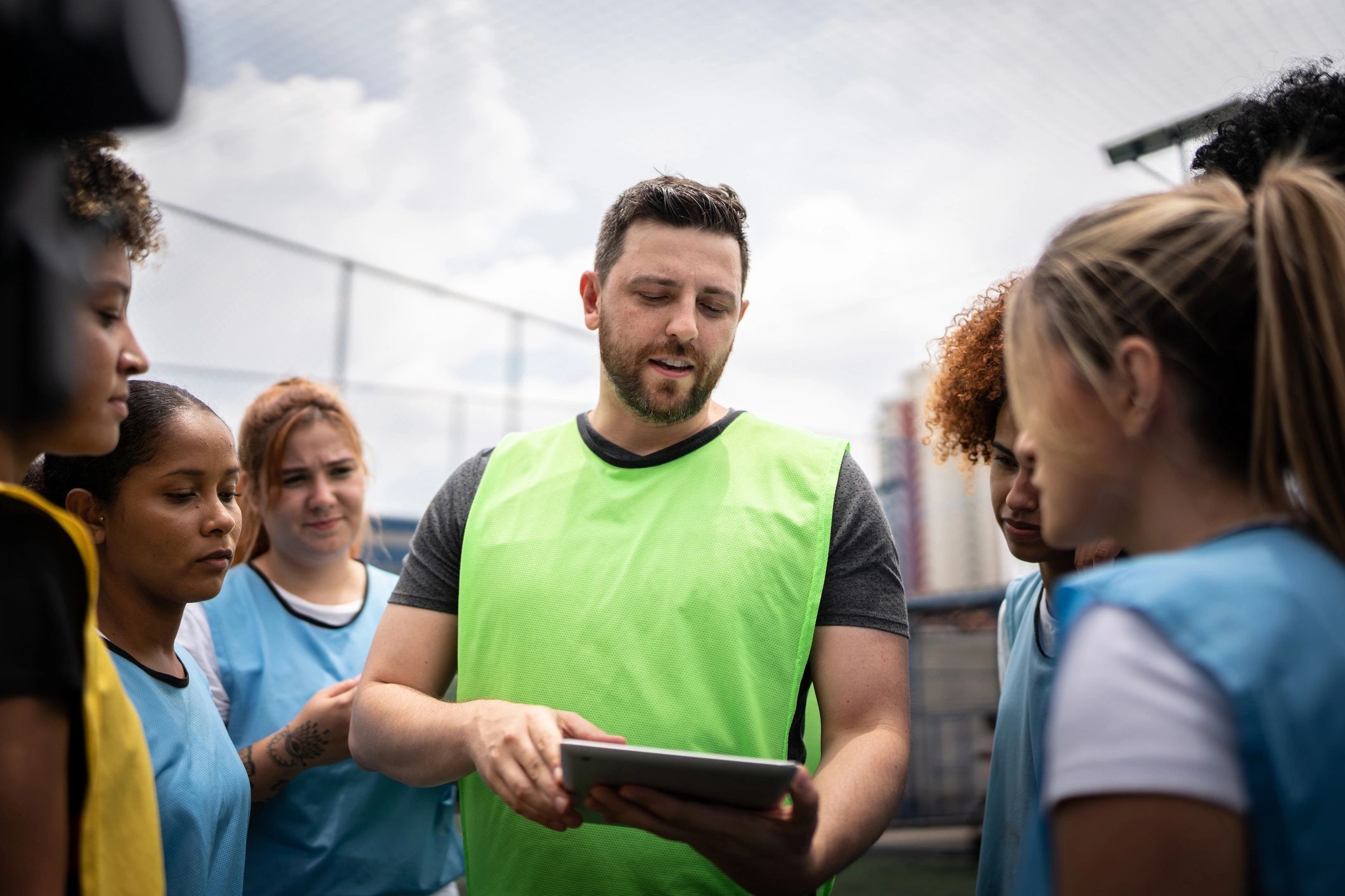 Coach and players in a team huddle (testimonial avatar placeholder)
