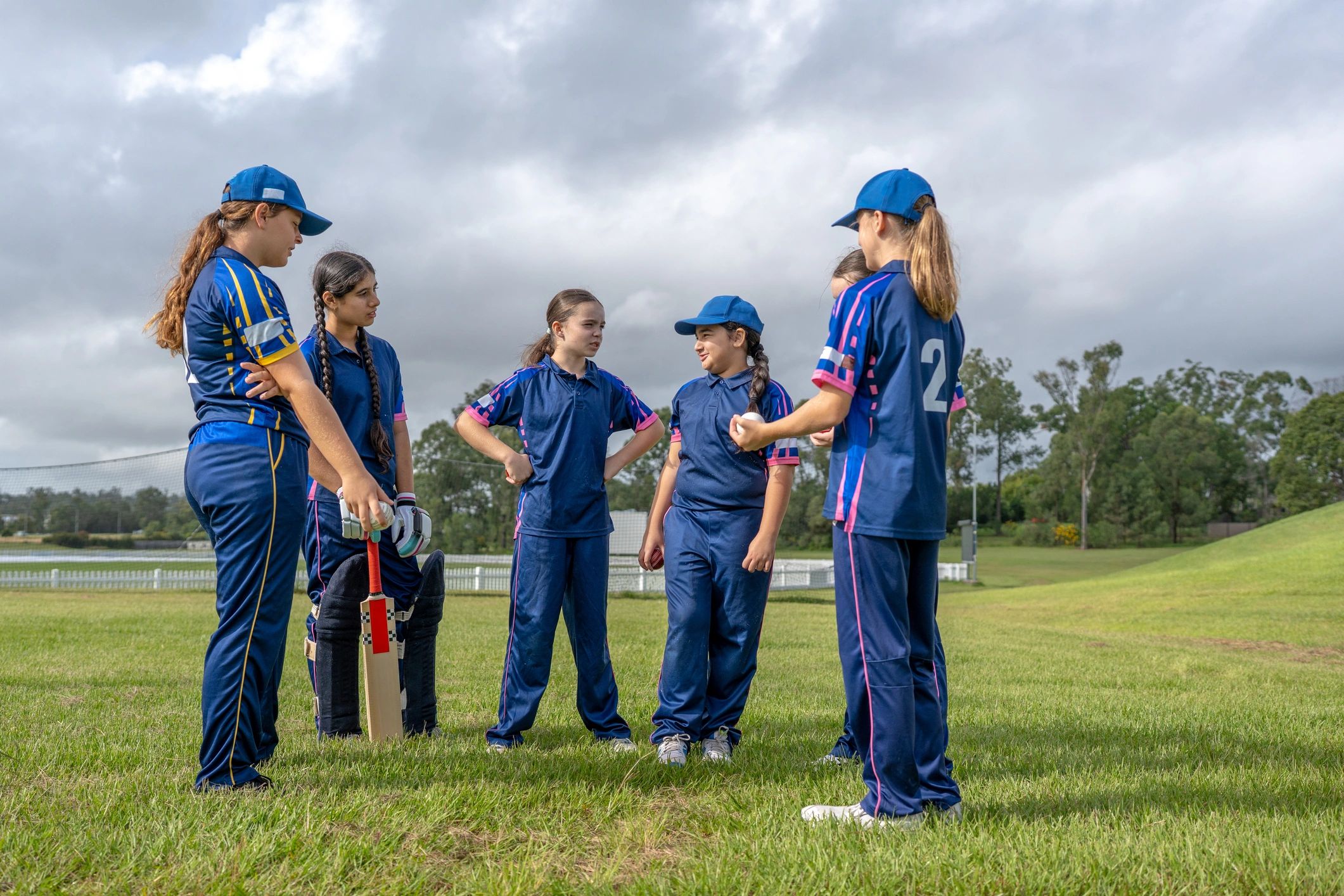Youth cricket team huddle during a discussion