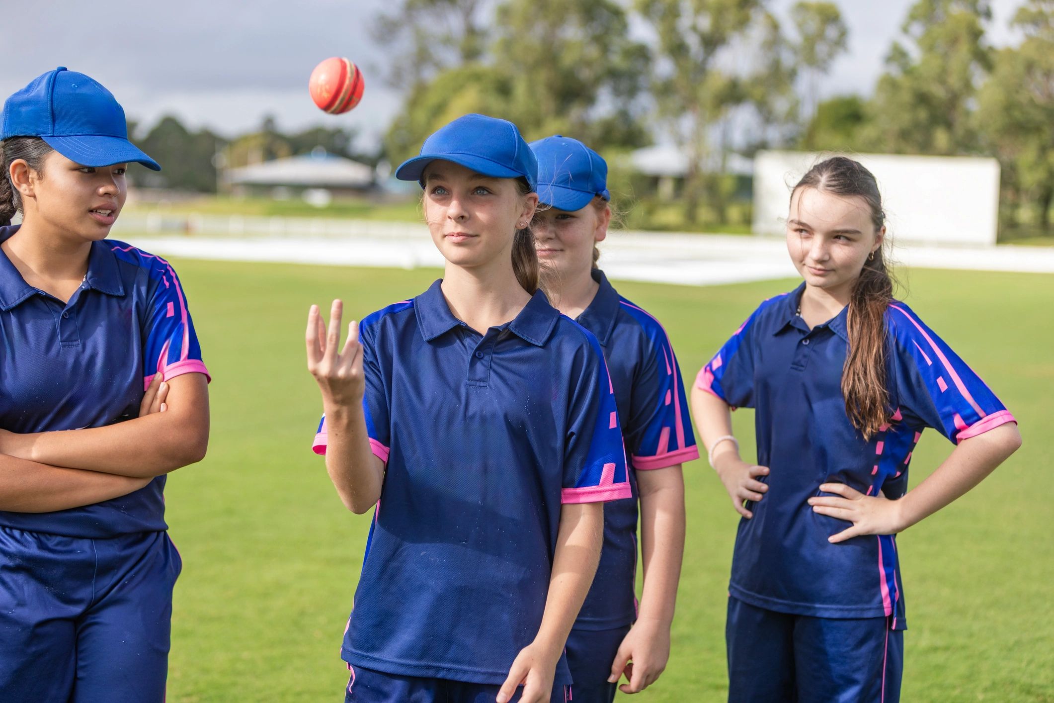 Teenage girls practising cricket