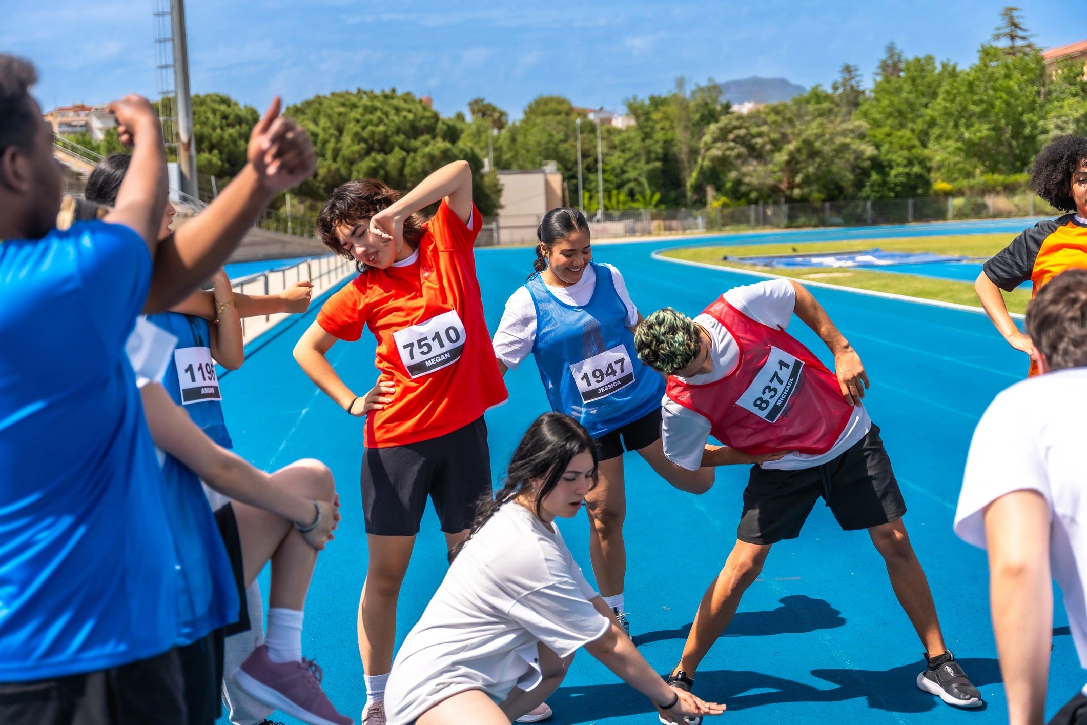Teen athletes stretching together before training