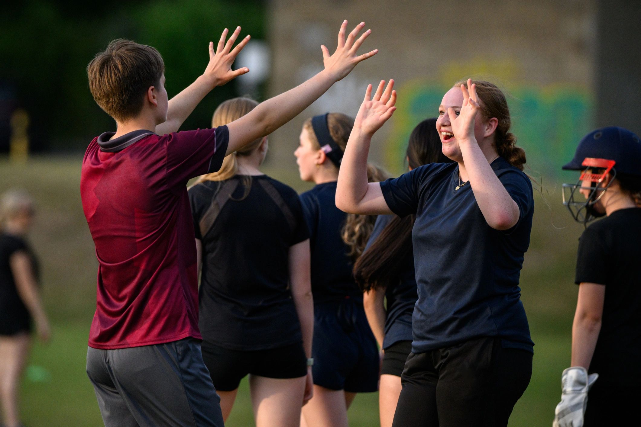 Teen athletes celebrating together after scoring