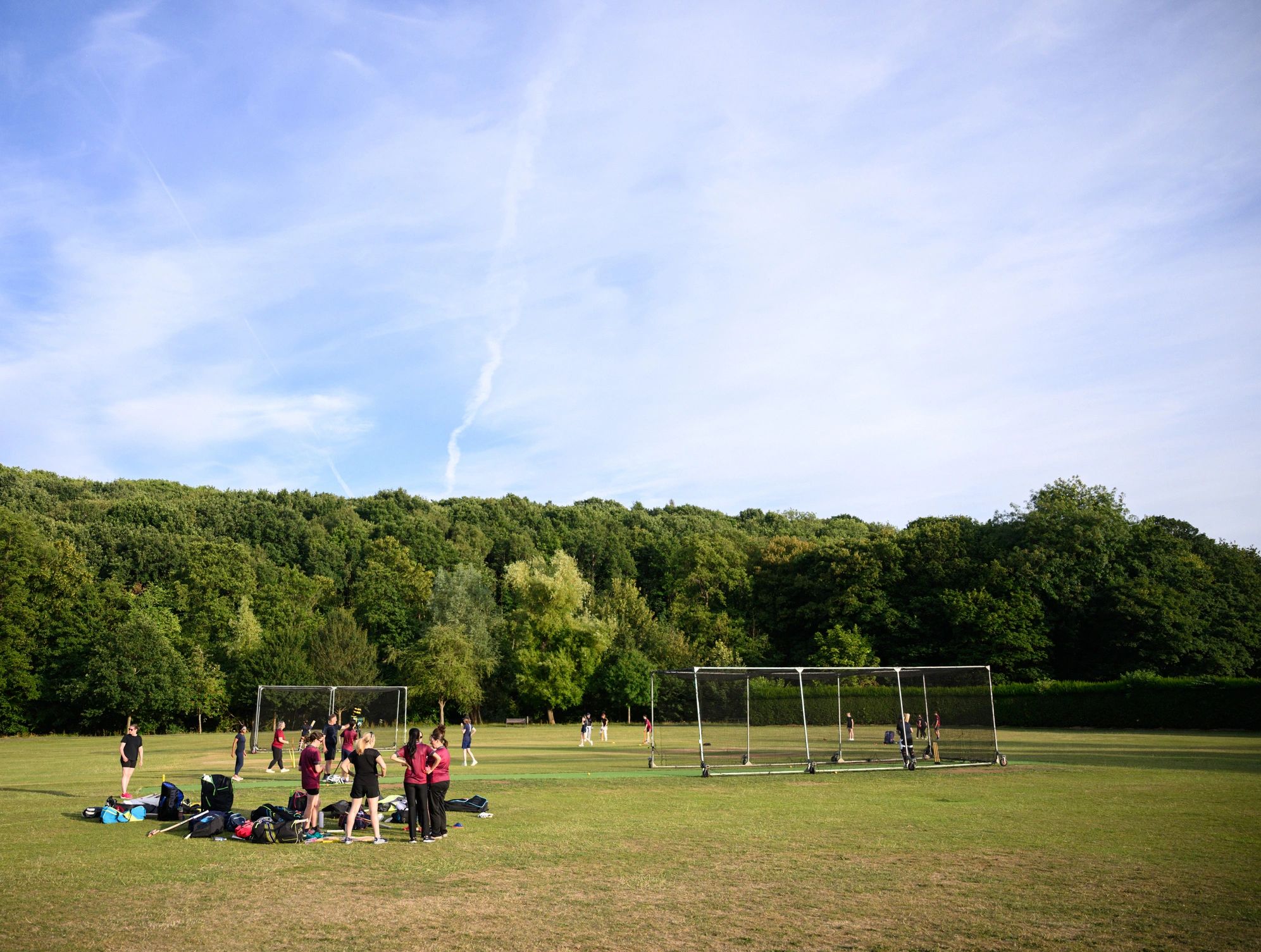 Cricket pitch with players gathering for practice