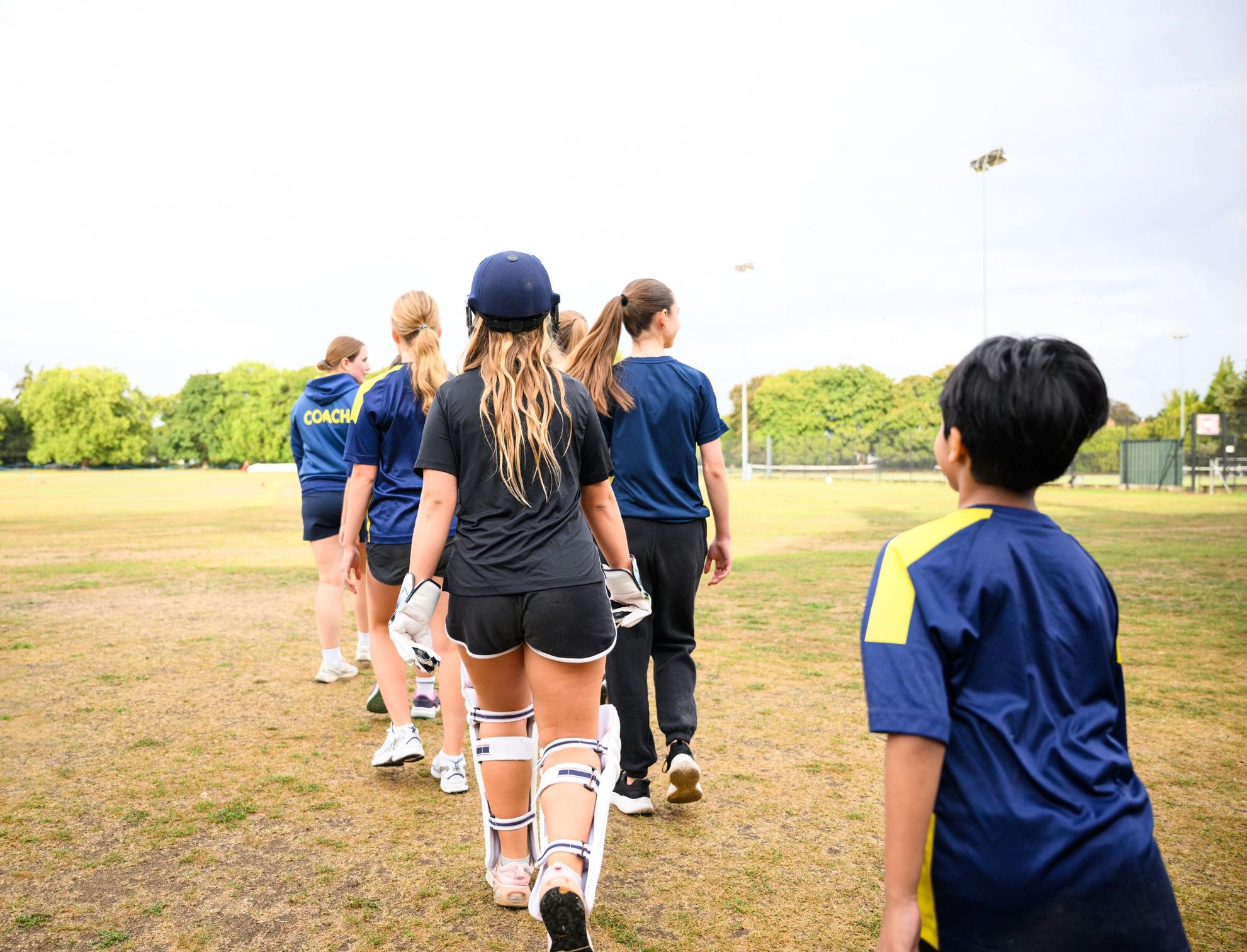 Youth players walking onto the cricket field for training